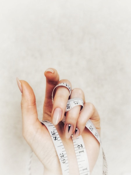 person with white and brown manicure