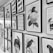 A collection of framed black-and-white illustrations and prints on a wall, including shoes, birds, floral designs, and abstract portraits. The artwork is diverse, featuring various styles and subjects, all mounted in matching black frames against a light-colored wall.