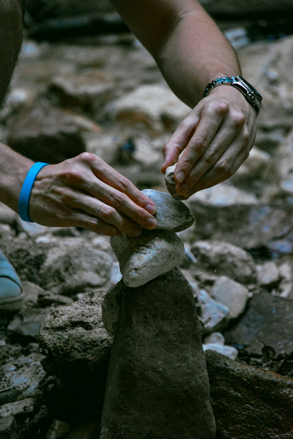 person holding gray stone during daytime