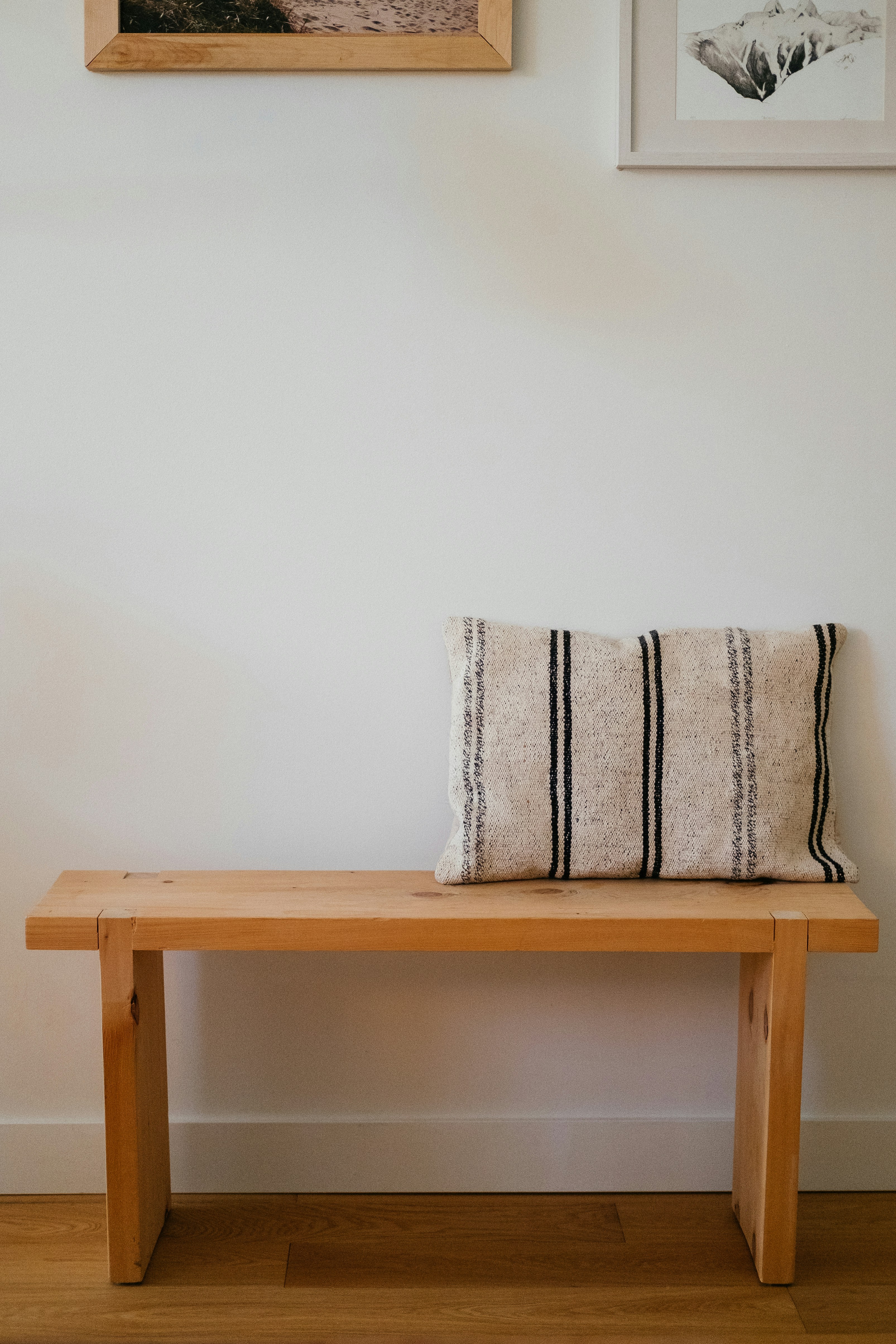 white and blue throw pillow on brown wooden chair