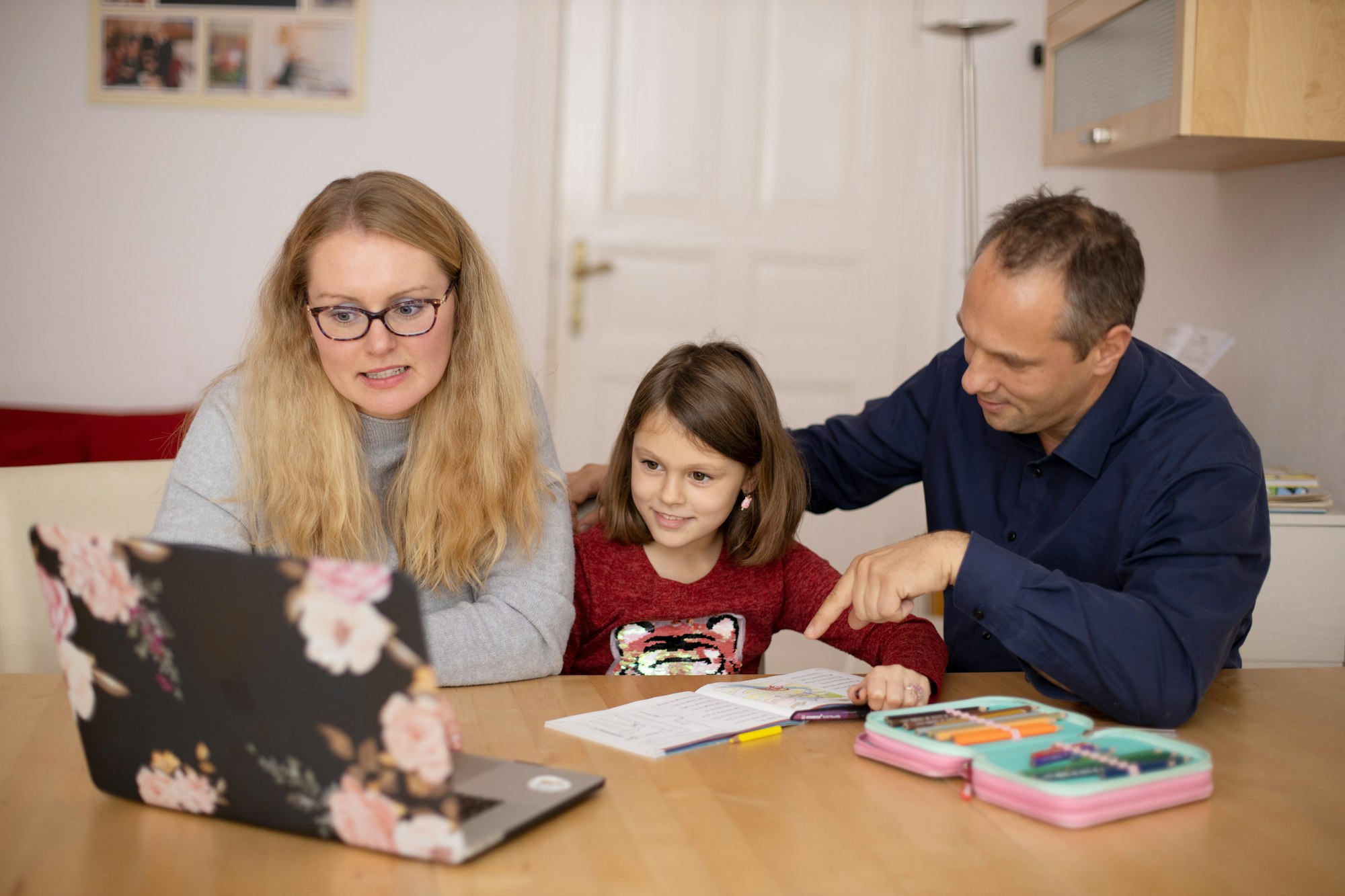 Parents learning together with their child during homeschooling.