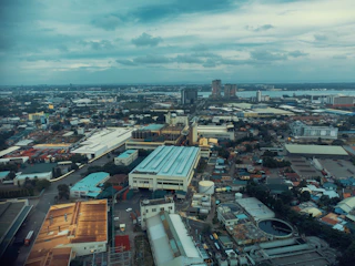 A sleek aerial view of an expansive industrial zone in Istanbul with modern factories and logistics hubs under a clear sky.