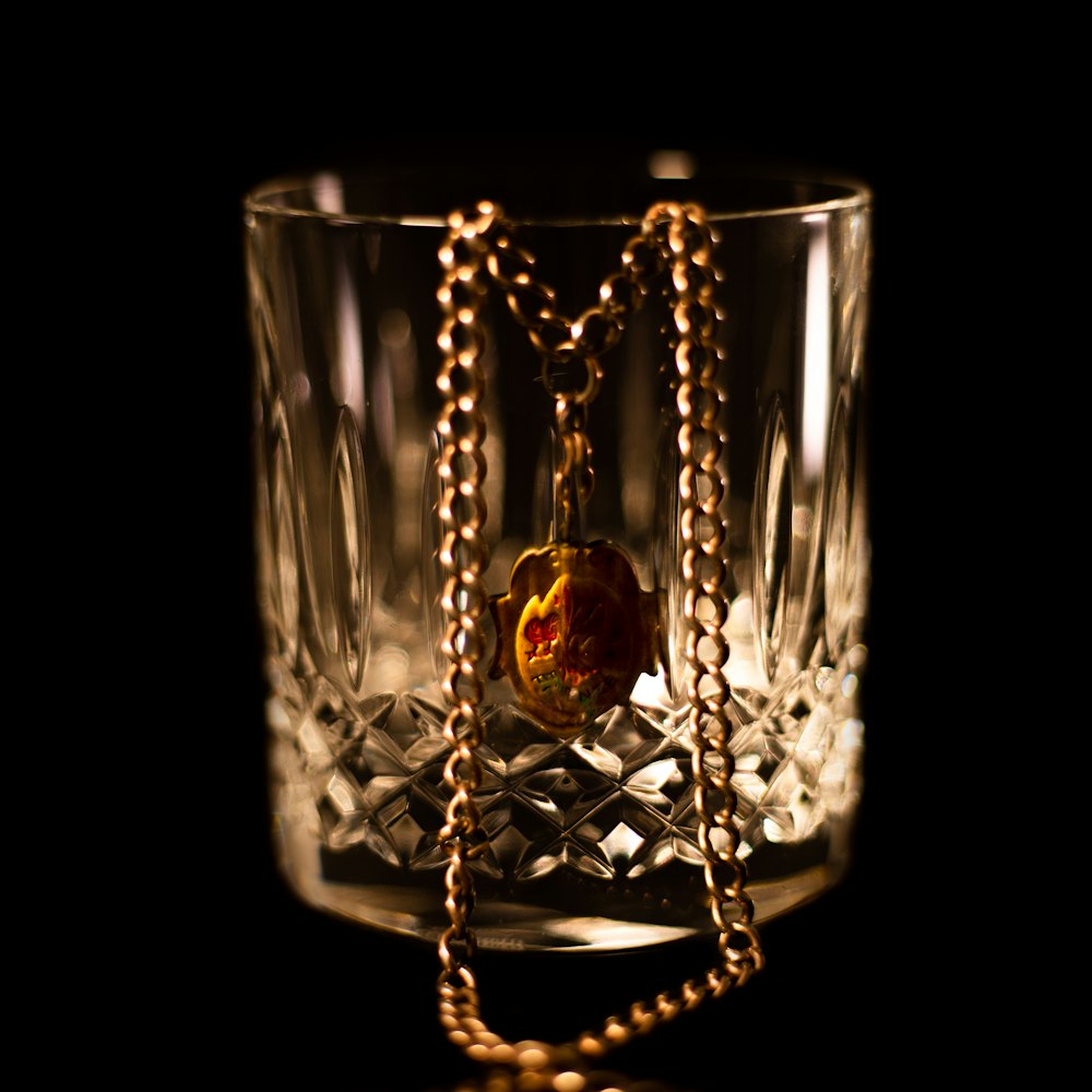a glass with a chain hanging from it