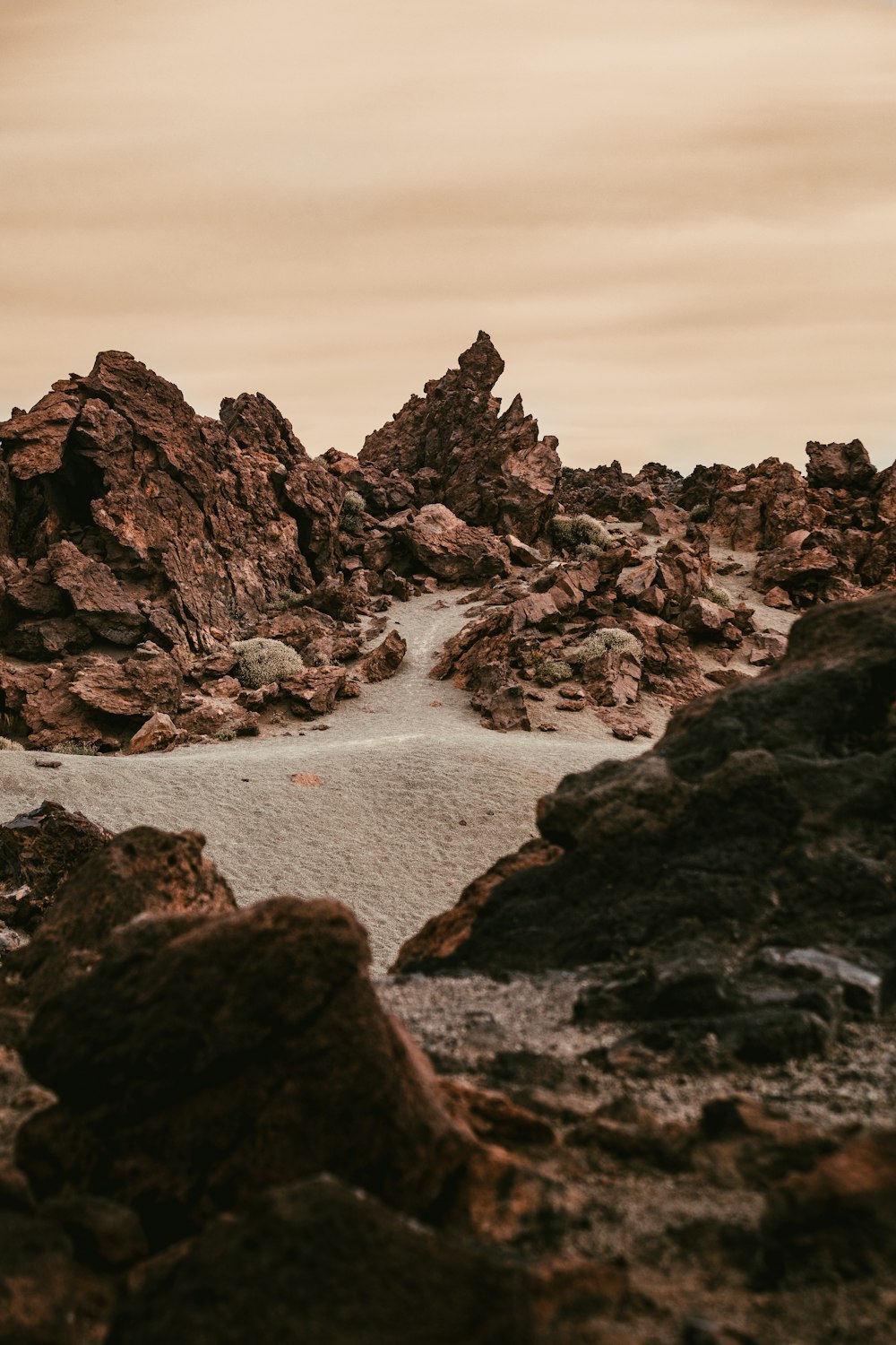 black rock formation on body of water