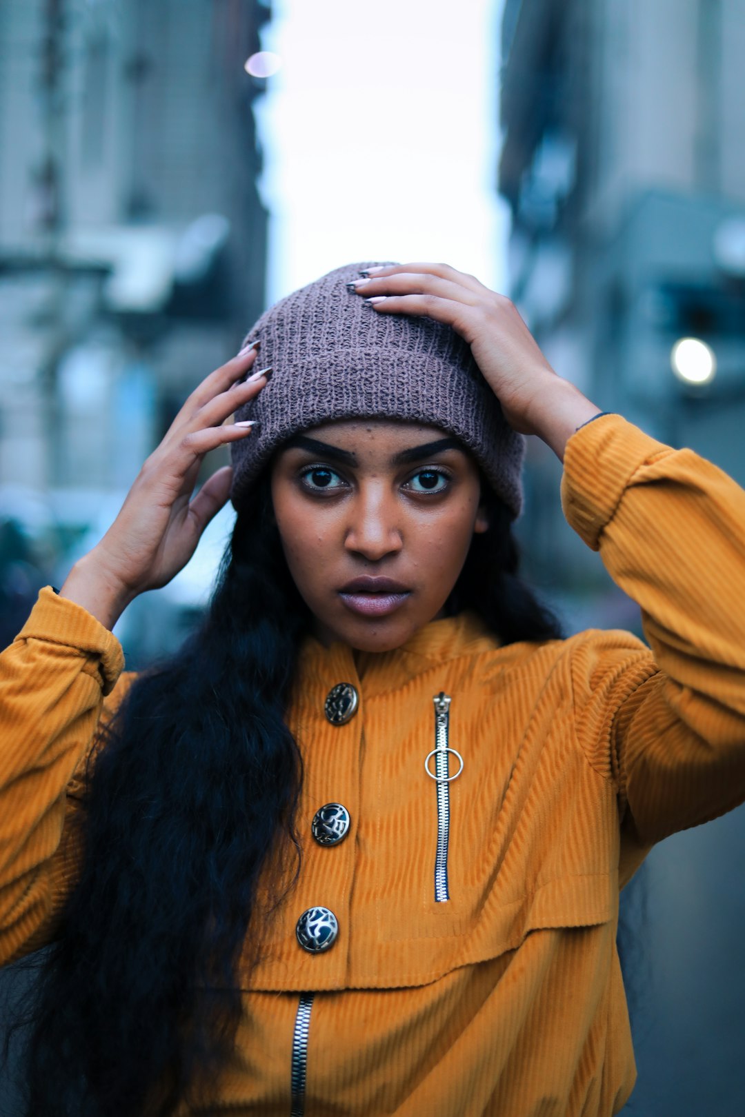 woman in yellow long sleeve shirt wearing gray knit cap