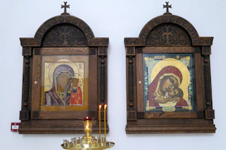 Handcrafted wooden frame with intricate religious art displayed in a cozy Puebla home setting