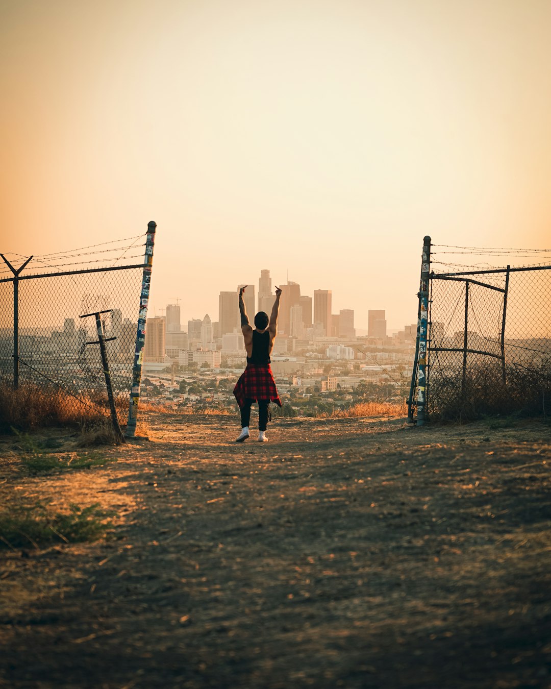 girl in red jacket standing on brown field during daytime