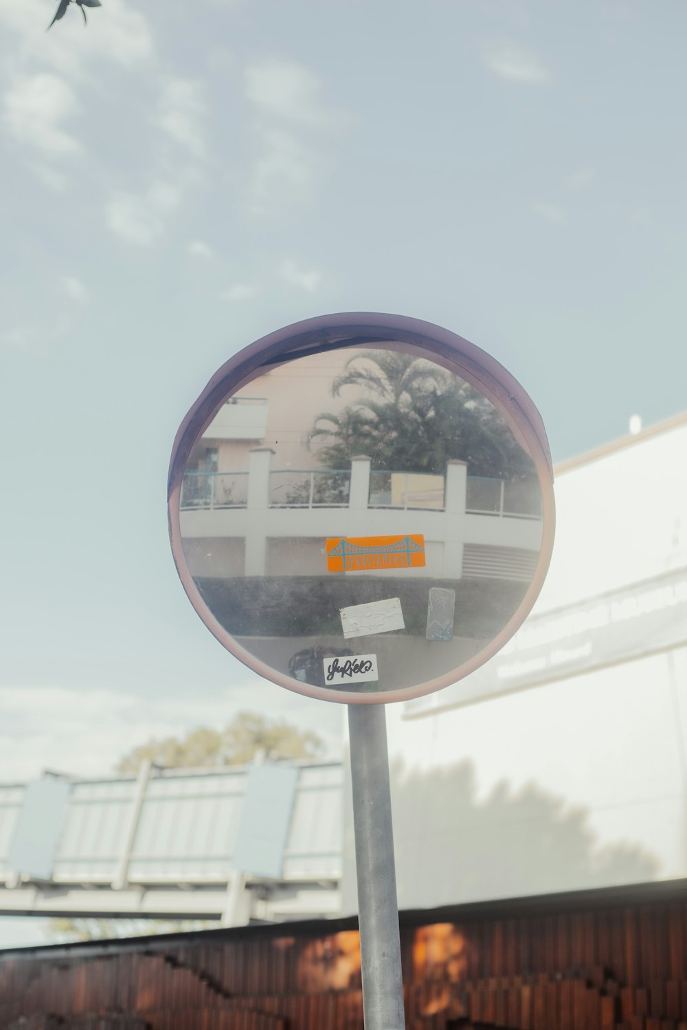 round mirror with reflection of buildings