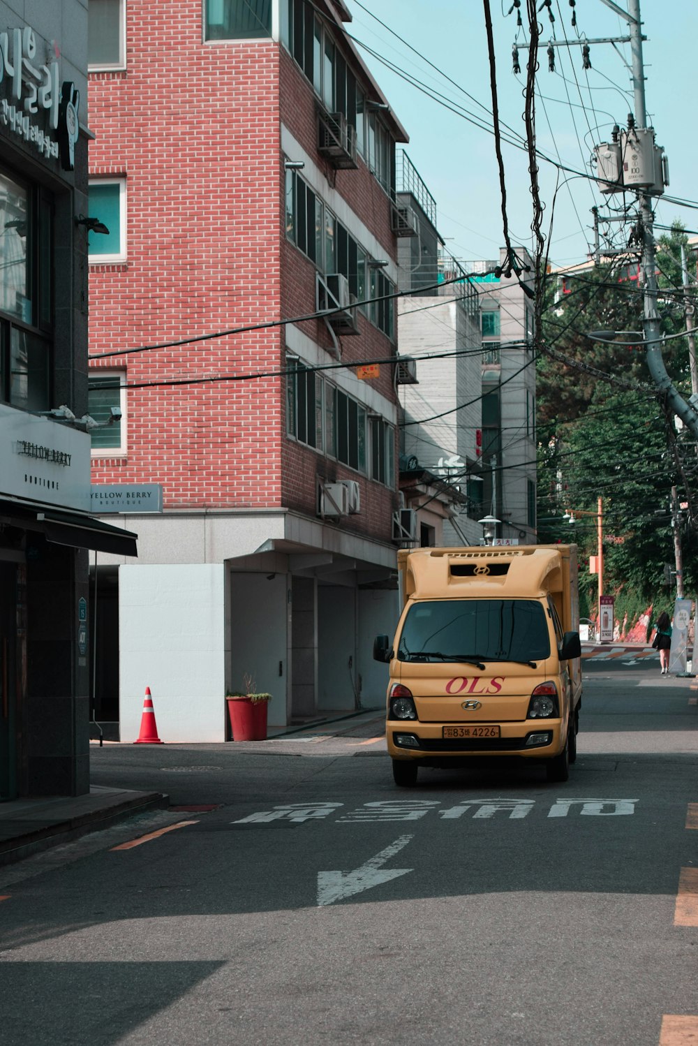 yellow van parked in front of brown building