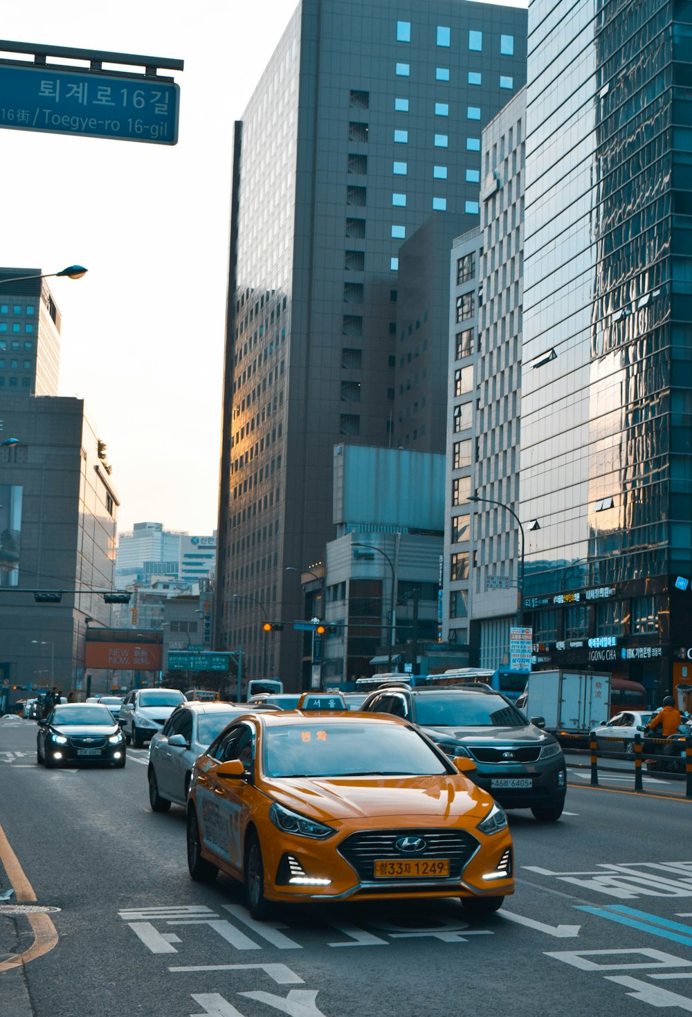 cars on road near high rise buildings during daytime