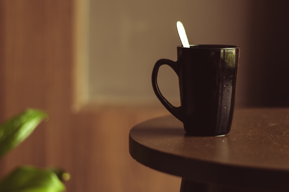 black ceramic mug on brown wooden table