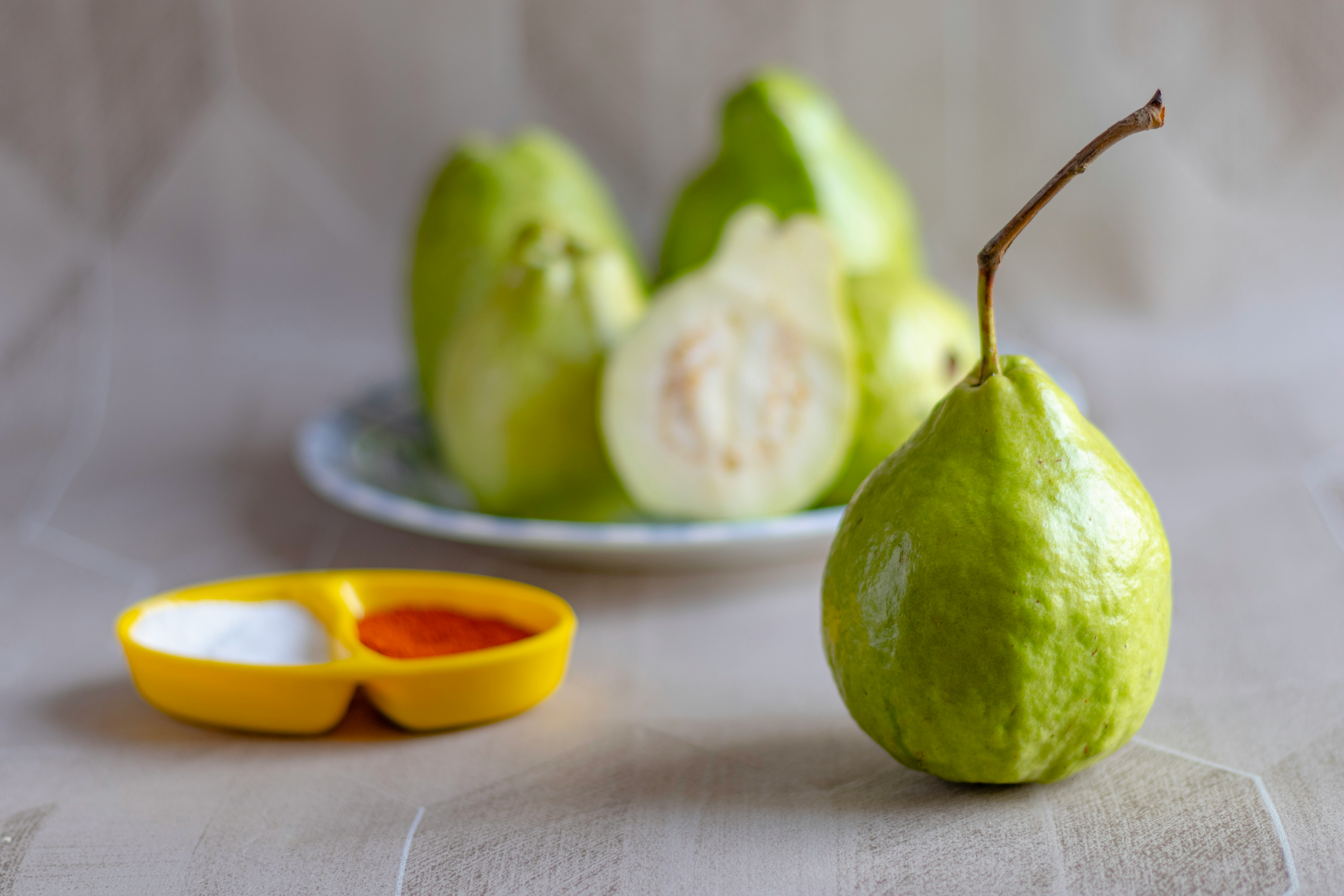 green fruit on white table