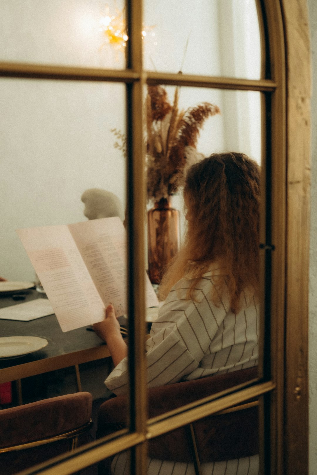 woman reading book on table