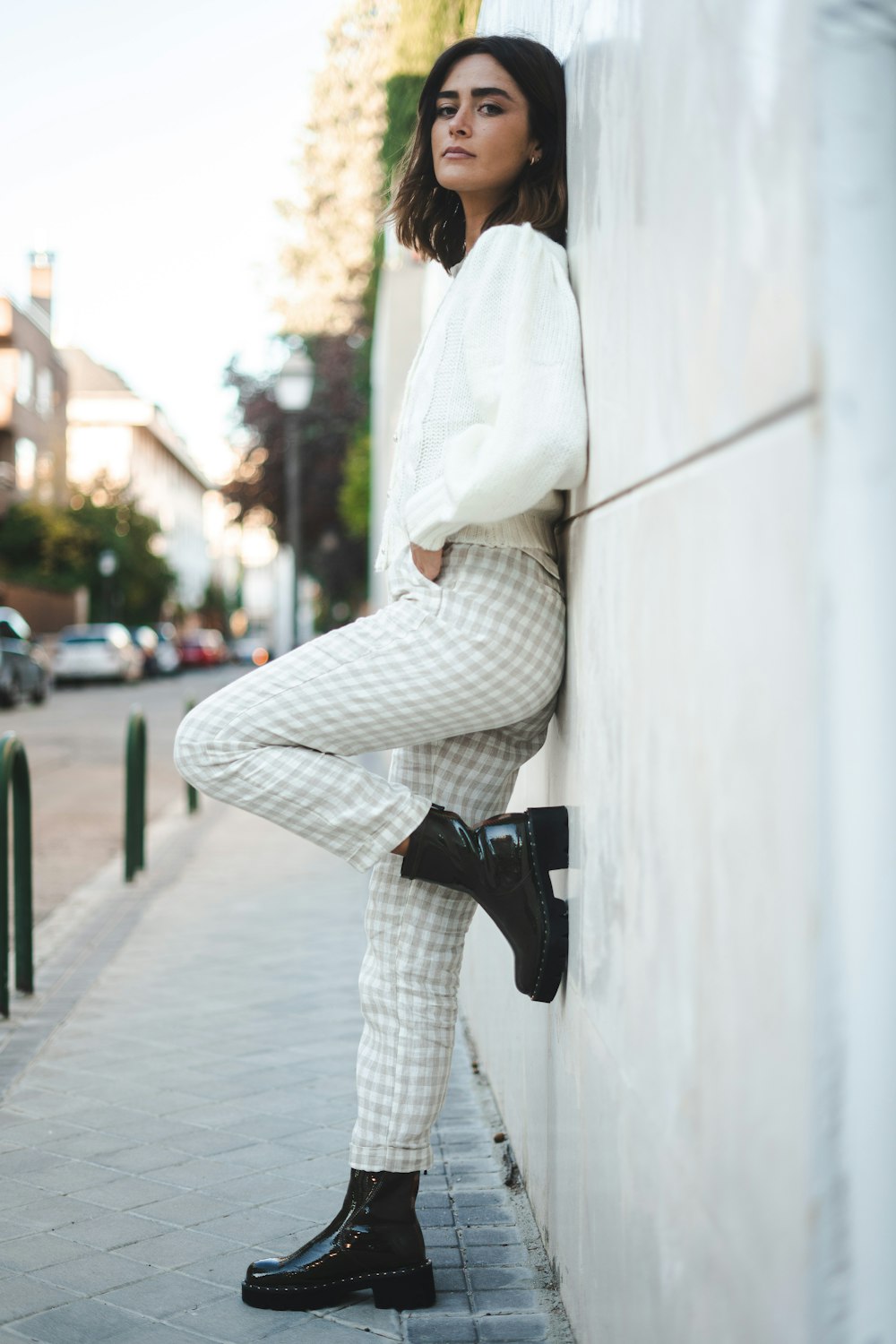 woman in white long sleeve shirt and white pants holding black dslr camera