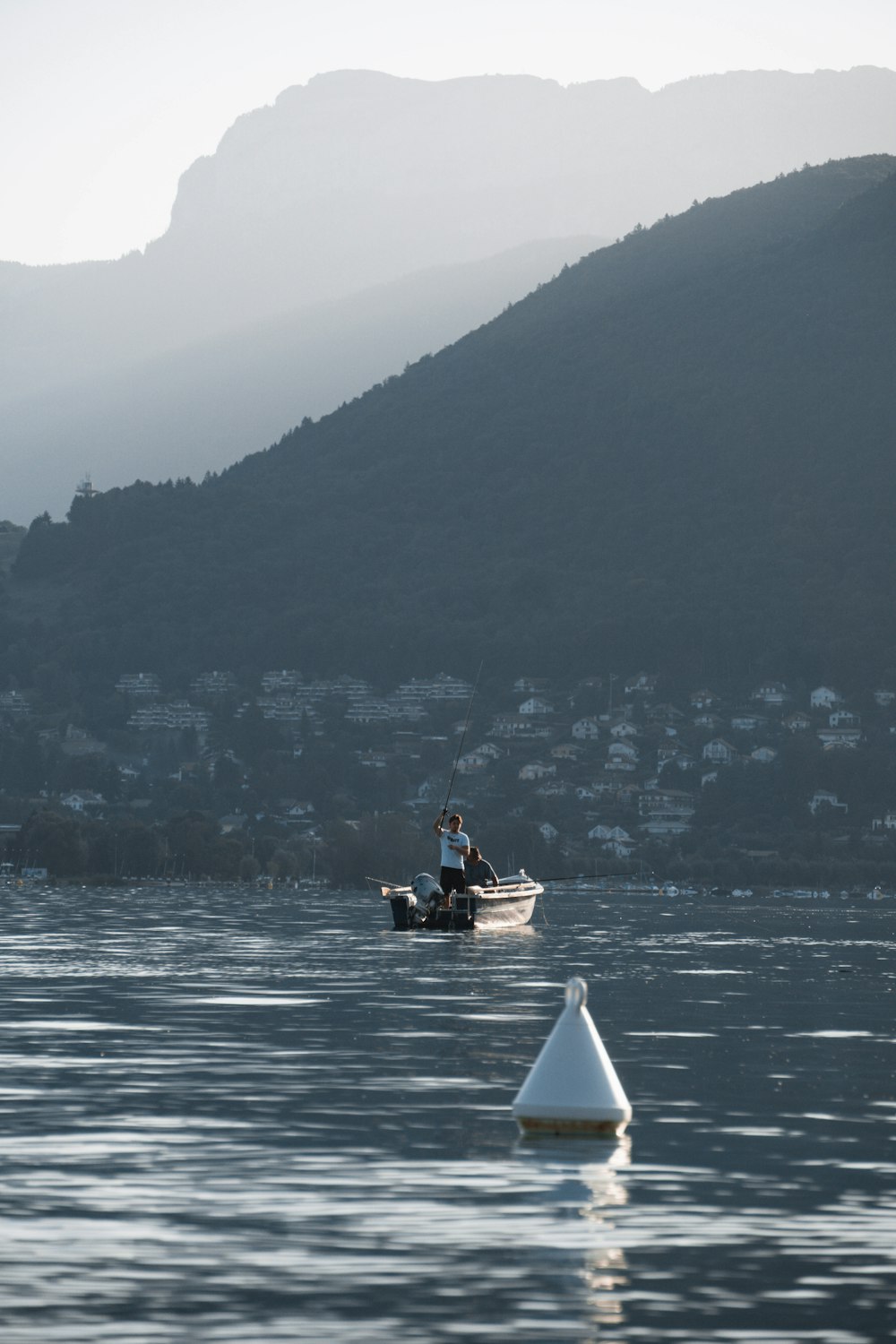 man in white and black boat on sea during daytime