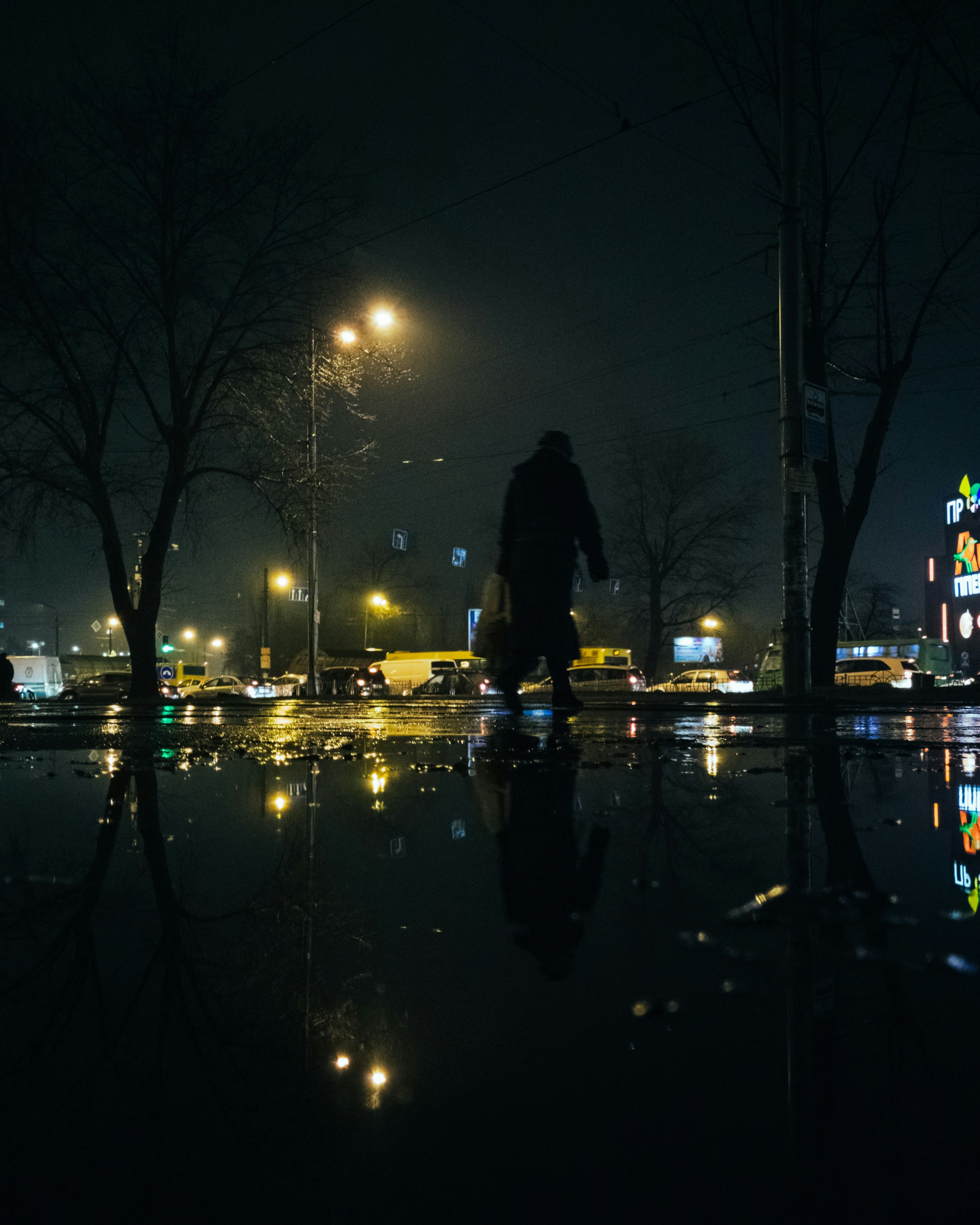 Girl alone in rain at night, city lights reflecting on wet street, dark emotional cinematic atmosphere