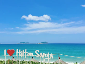 A vibrant scenic view of Hainan's tropical beaches with tourists enjoying the sun.