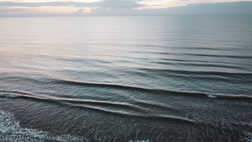 body of water under cloudy sky during daytime