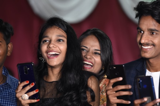 A group of high school students engaging with social media on smartphones in a classroom setting