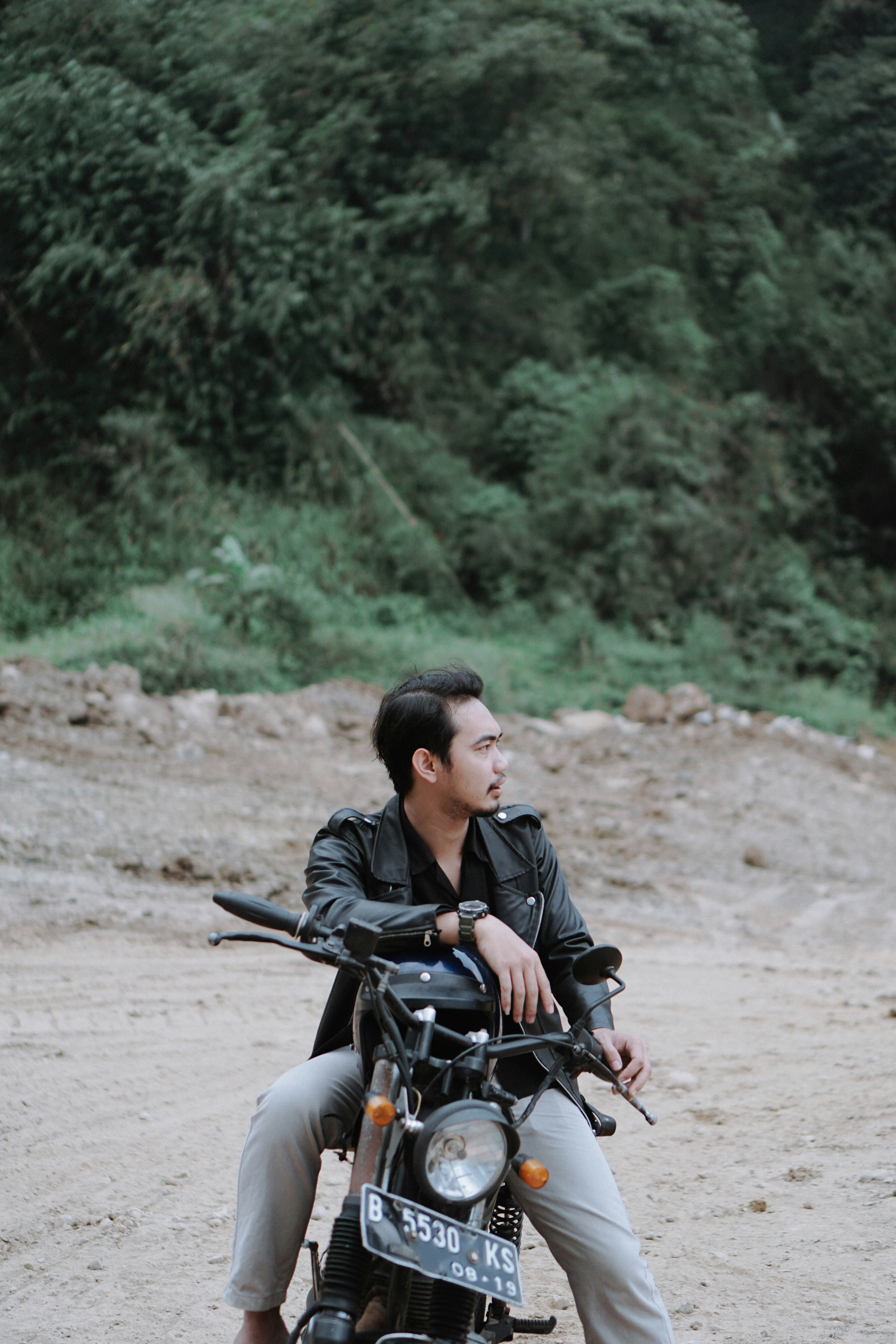 woman in black jacket riding motorcycle during daytime