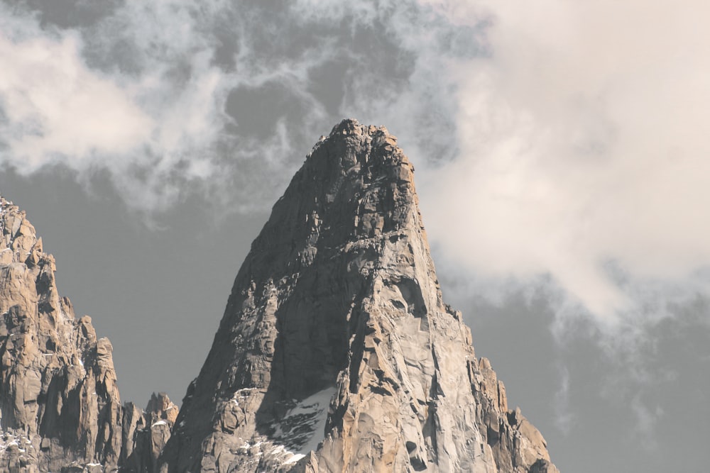 brown rock formation under white clouds during daytime