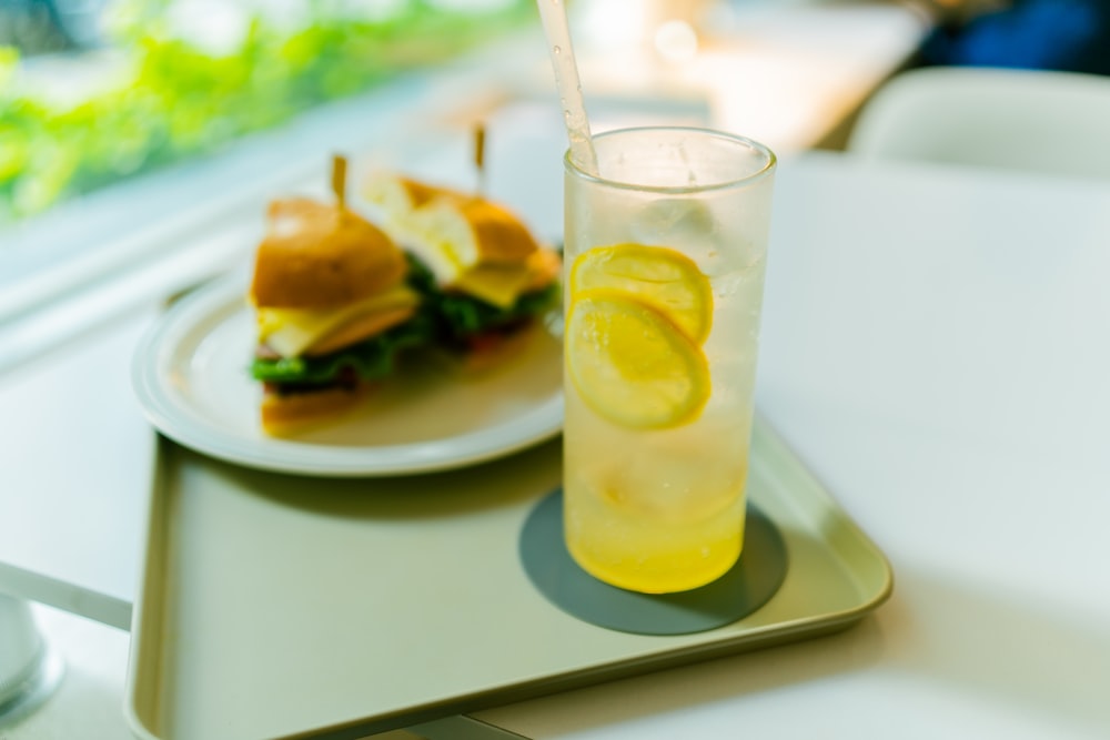 clear drinking glass with yellow liquid