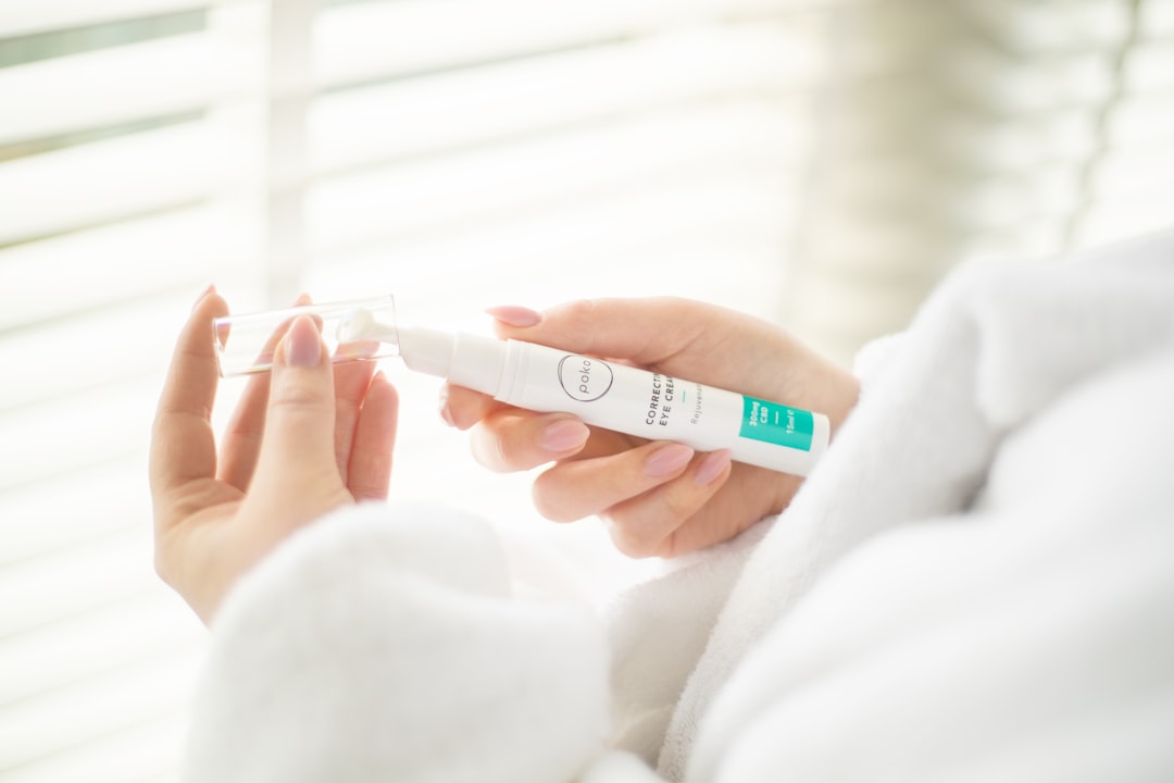 person holding white plastic tube