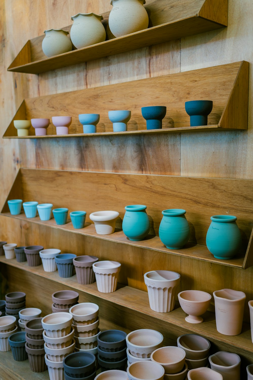 blue ceramic bowls on brown wooden shelf