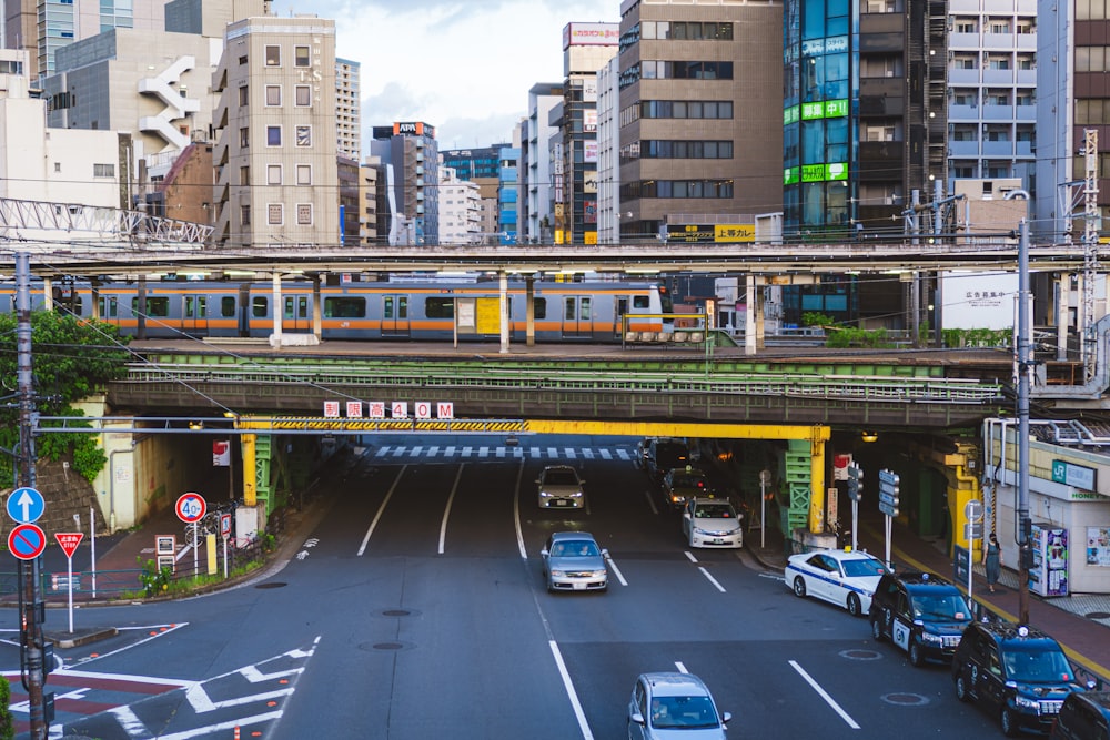 cars parked on side of the road near high rise buildings during daytime