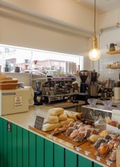 A cozy coffee shop counter with fresh coffee beans and brewing equipment neatly arranged.