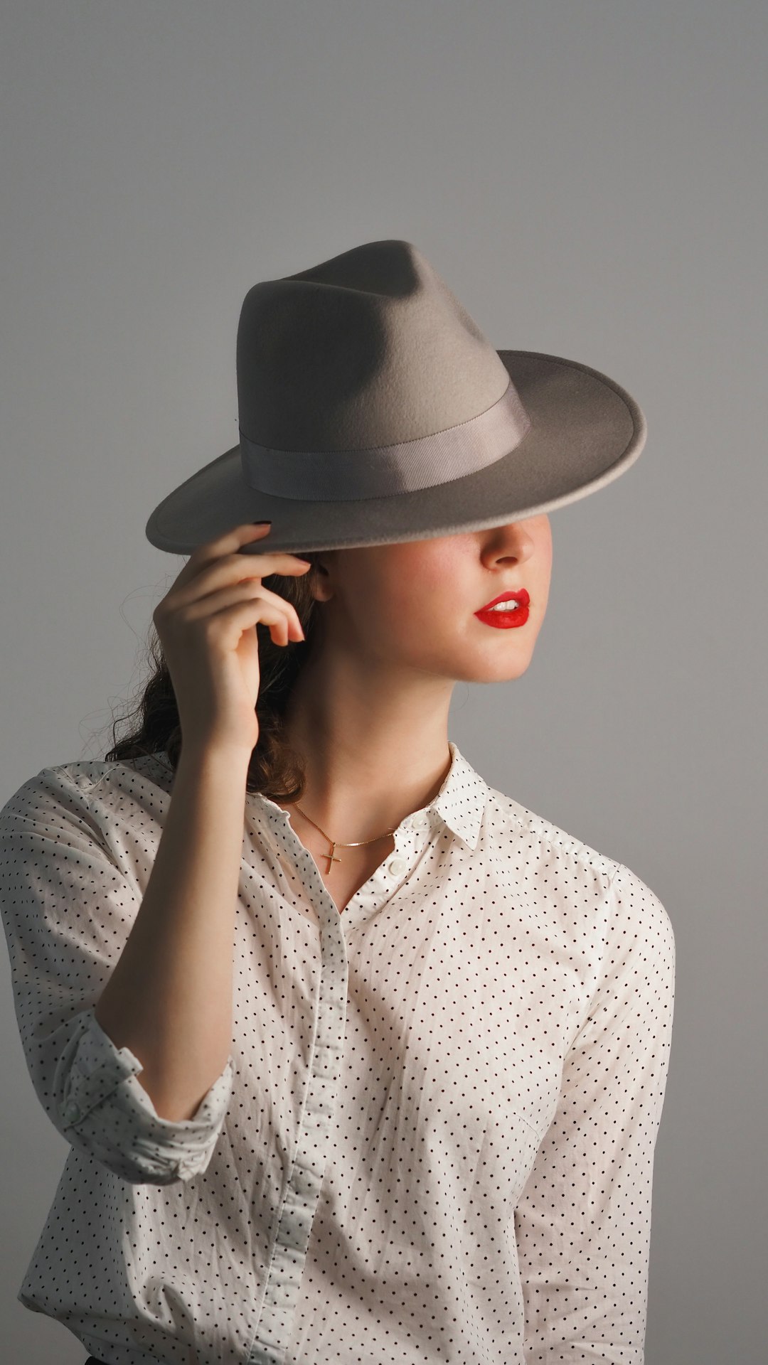 woman in gray hat and gray button up shirt