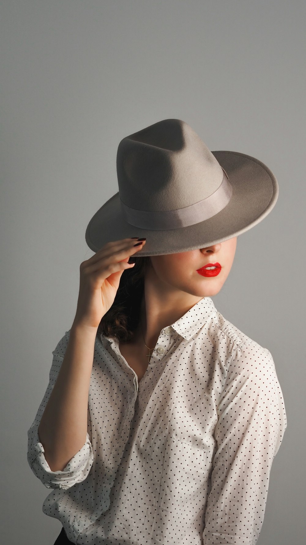 woman in grey hat and grey button up shirt