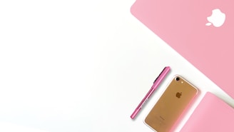 A modern pink-themed workspace showing a small business owner using pospink software on a tablet