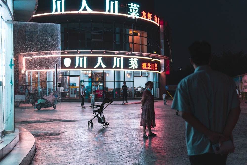 people walking on street during nighttime