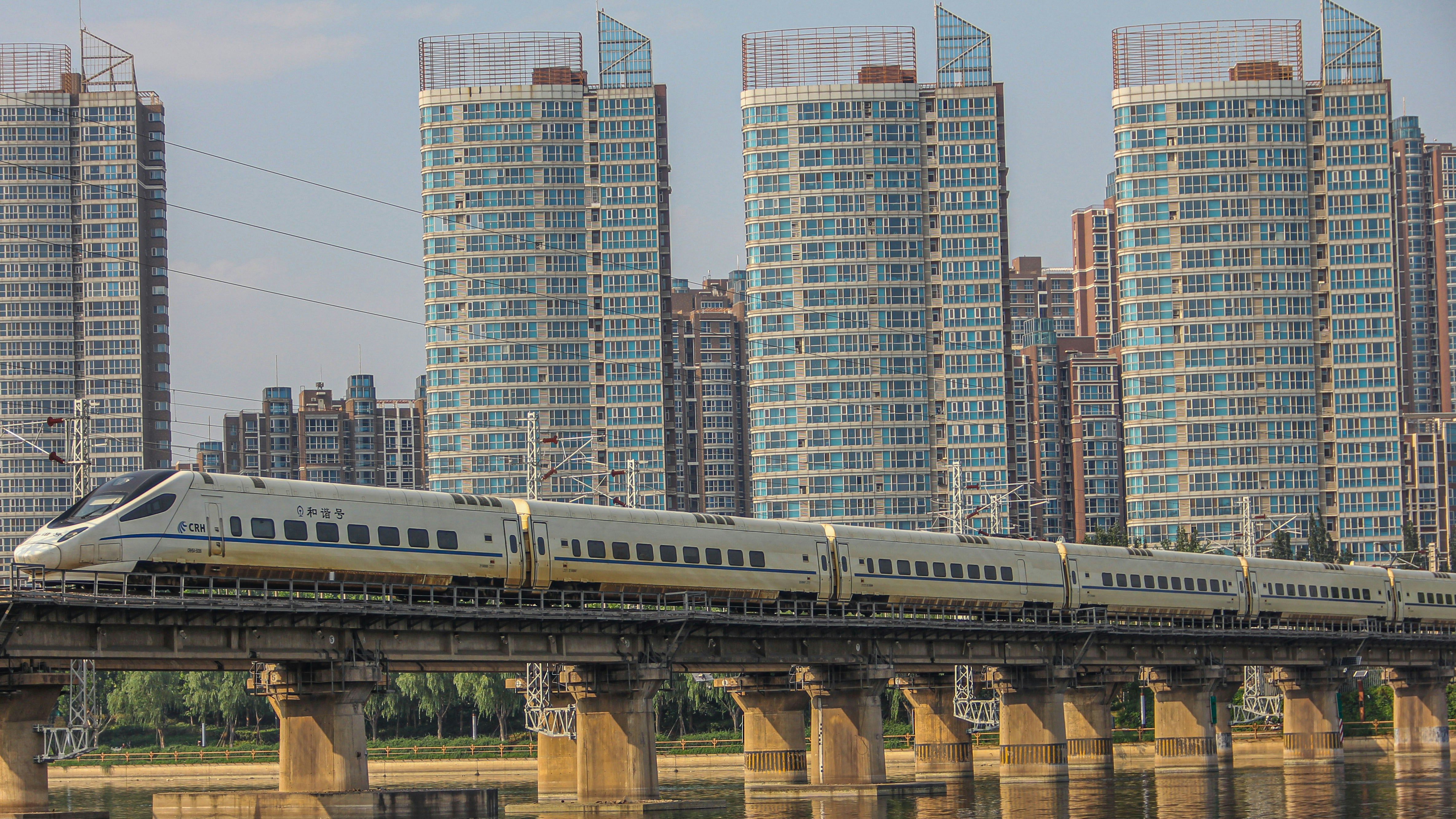 white and brown train on rail tracks