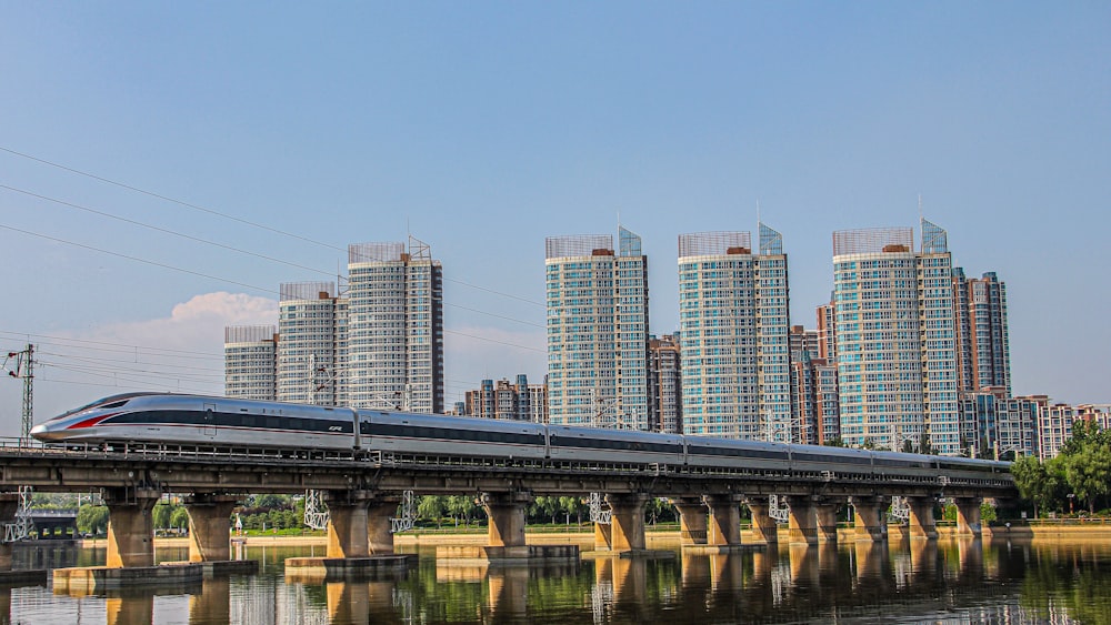 bridge over river near city buildings during daytime