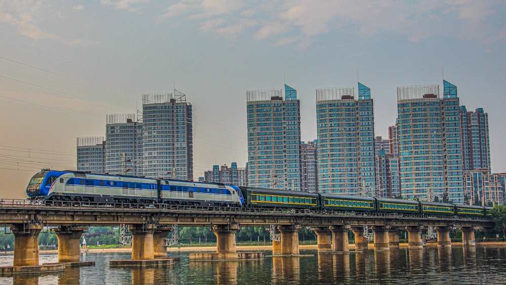 bridge over river near high rise buildings during daytime