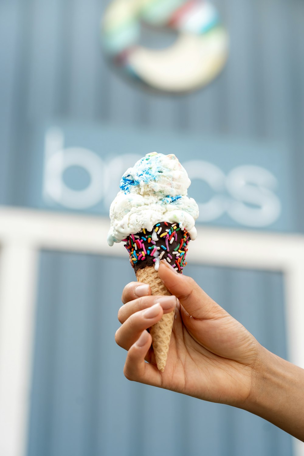 person holding ice cream cone with ice cream