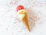 Close-up of a colorful ice cream cone with sprinkles on a sunny day.