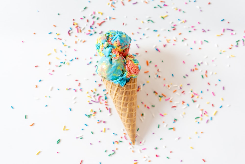 blue and green ice cream on brown cone
