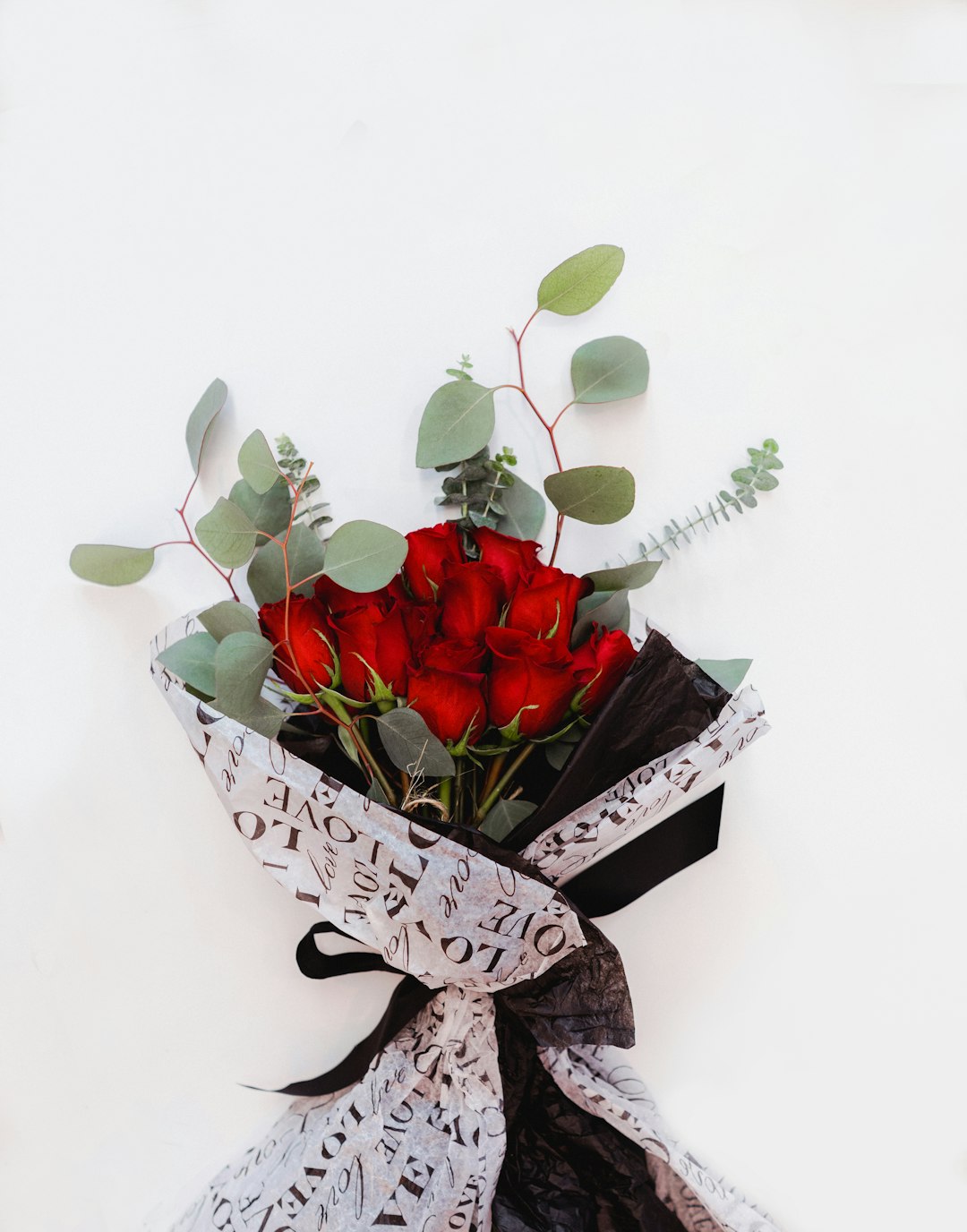 red roses on white and black floral basket