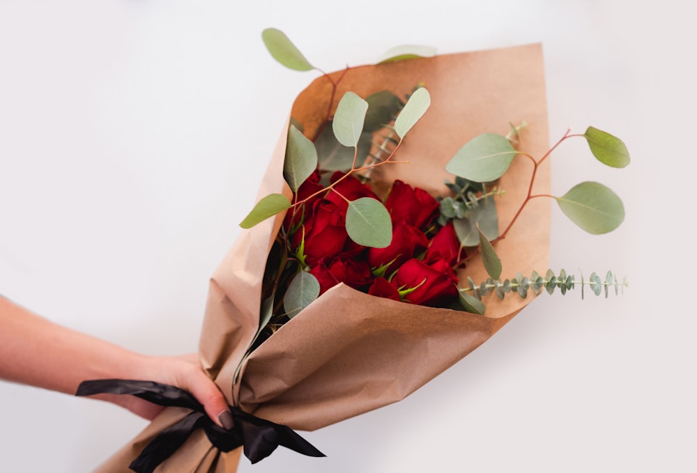 red roses on brown paper bag