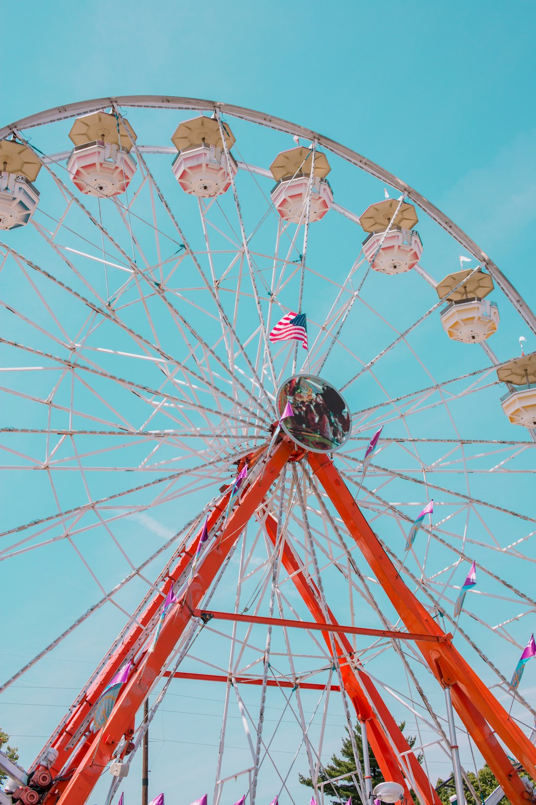 people riding on red and white ferris wheel during daytime