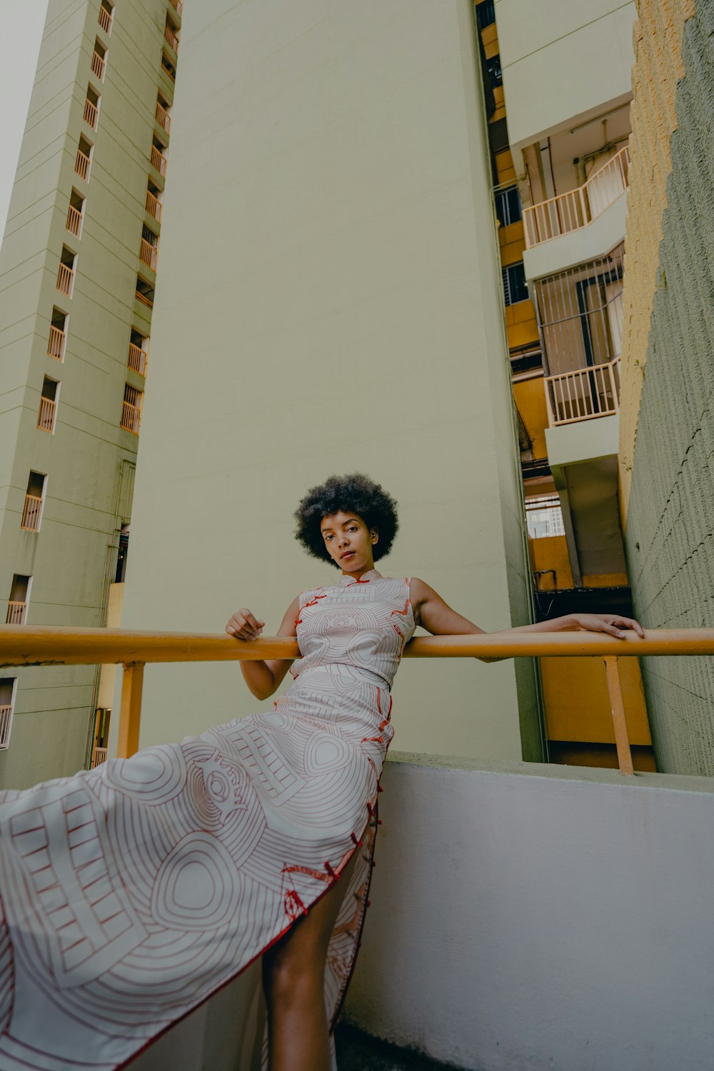 woman in white and red dress standing on yellow ladder