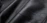 Close-up of a smooth, high-quality synthetic leather sample with a subtle grain texture.