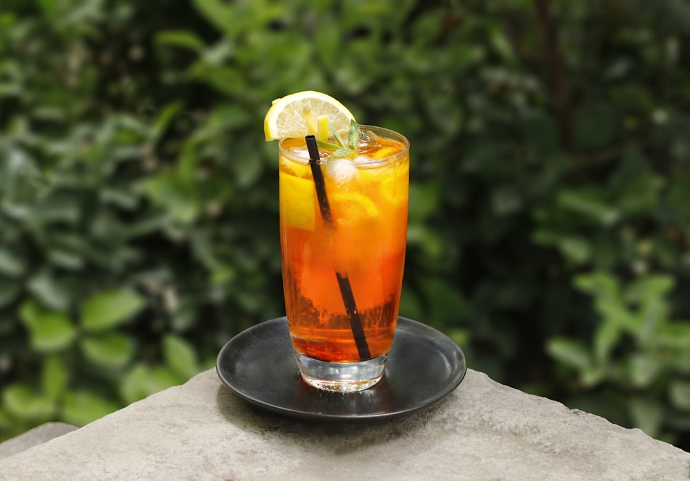 clear drinking glass with orange juice