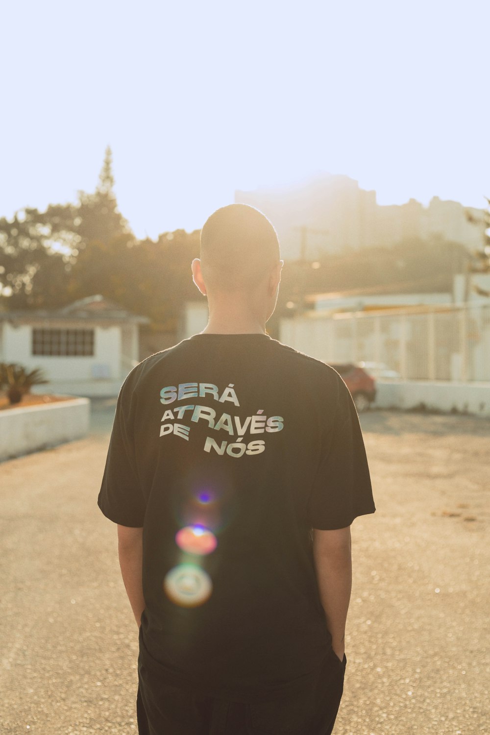 man in black crew neck t-shirt standing on brown sand during daytime