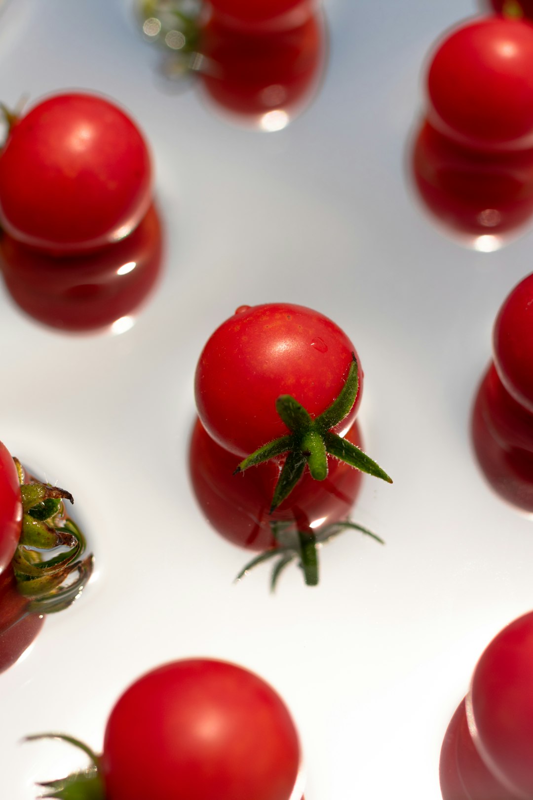 red cherry fruit on white surface