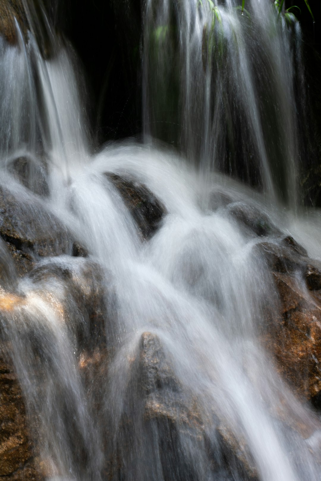 water falls on brown rock