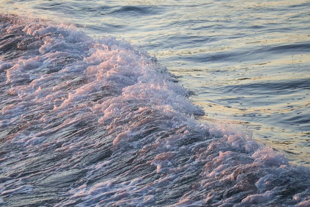 brown rock formation on body of water during daytime